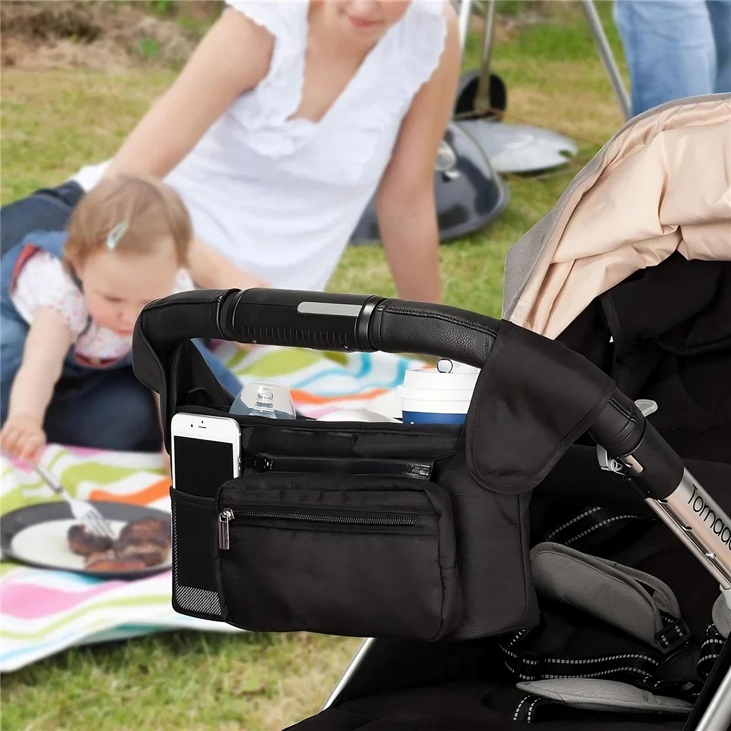 All in one stroller organizer with cup holders phone pocket and storage compartments depiction of use
