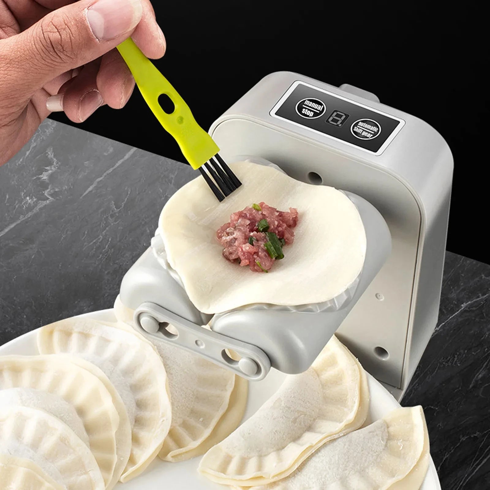 Automatic dumpling maker press for quick and easy homemade dumplings depiction of brushing with cooking oil