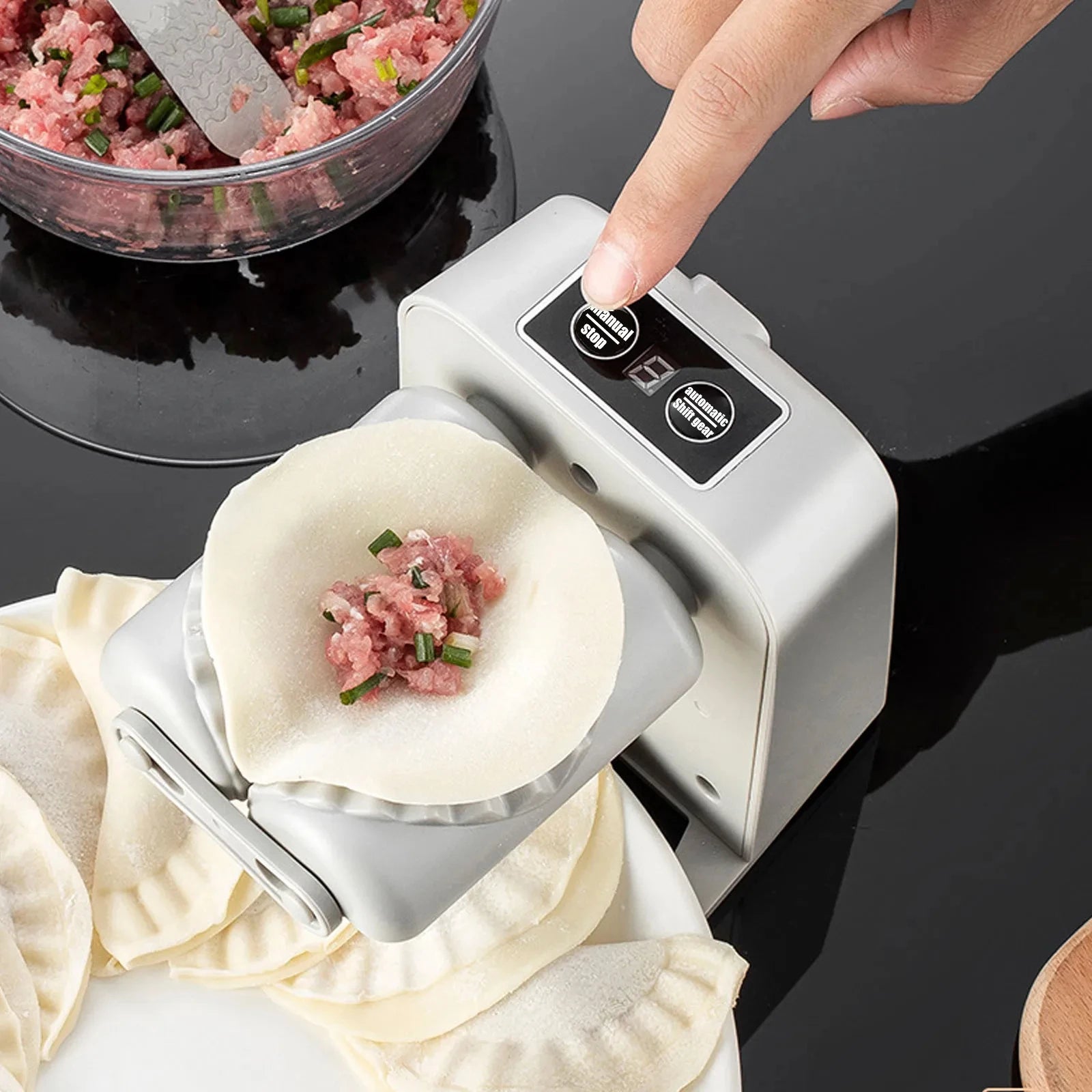 Automatic dumpling maker press for quick and easy homemade dumplings depiction of starting the automatic dumpling process