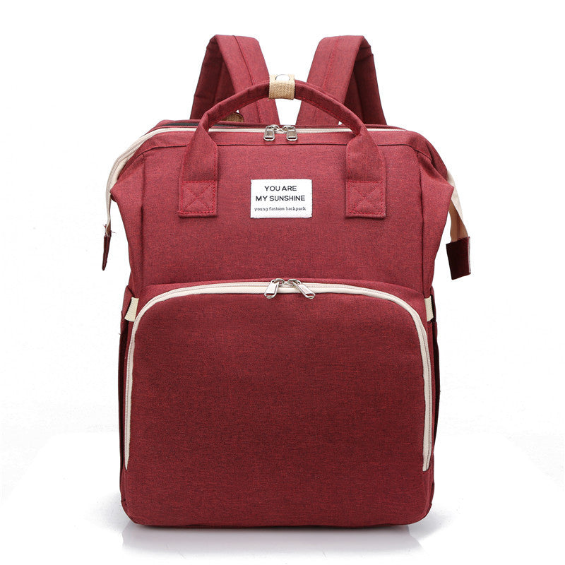 Baby diaper change backpack in red color with organized storage pockets cushioned straps and portable changing design (Color: Red)