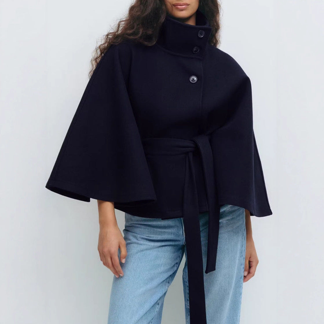 Batwing sleeve trench coat in navy blue color with high neck loose fit and button front design model shot (Color: Navy Blue)