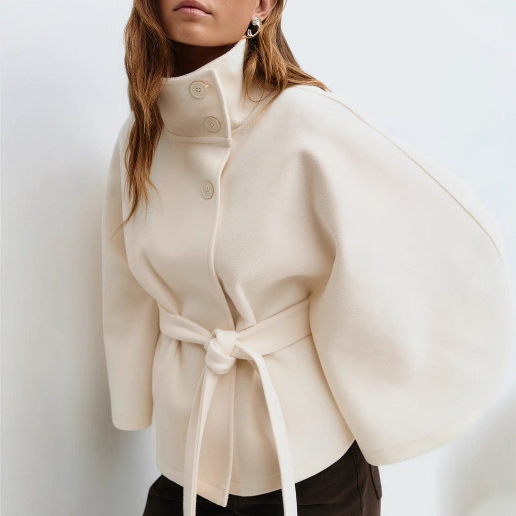 Batwing sleeve trench coat in white color with high neck loose fit and button front design model shot (Color: White)