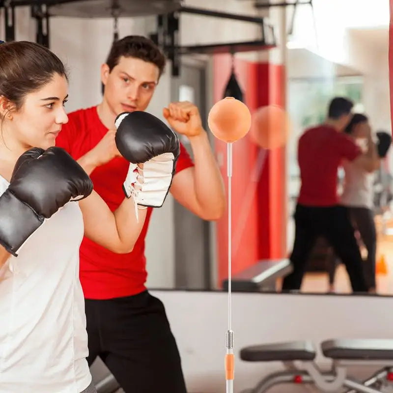 Boxing reflex punching bag with adjustable stand for speed coordination and home training depiction of at gym training