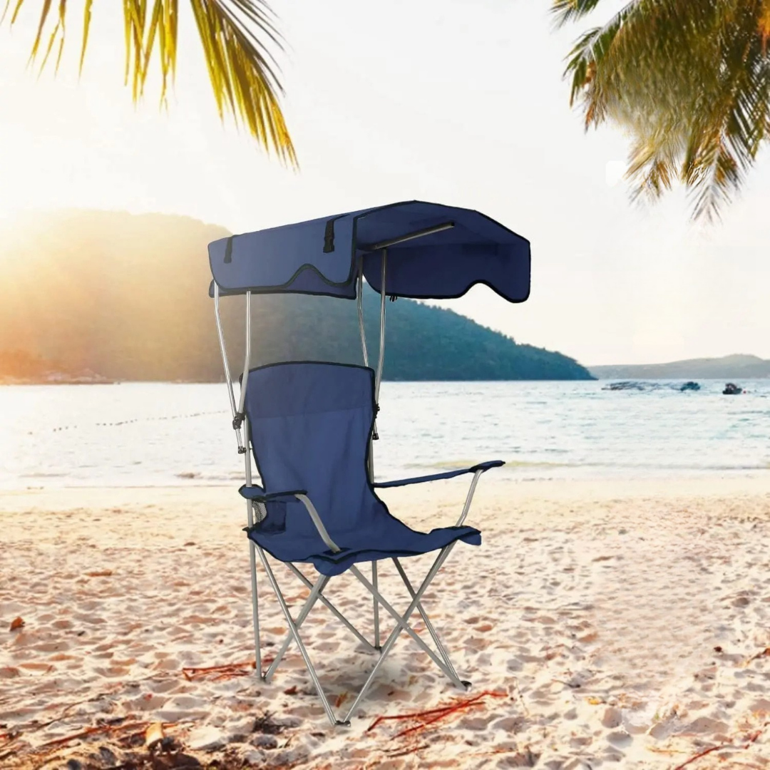 Camping chair with canopy sunshade and side panels for outdoor comfort and sun protection product shot in a beach