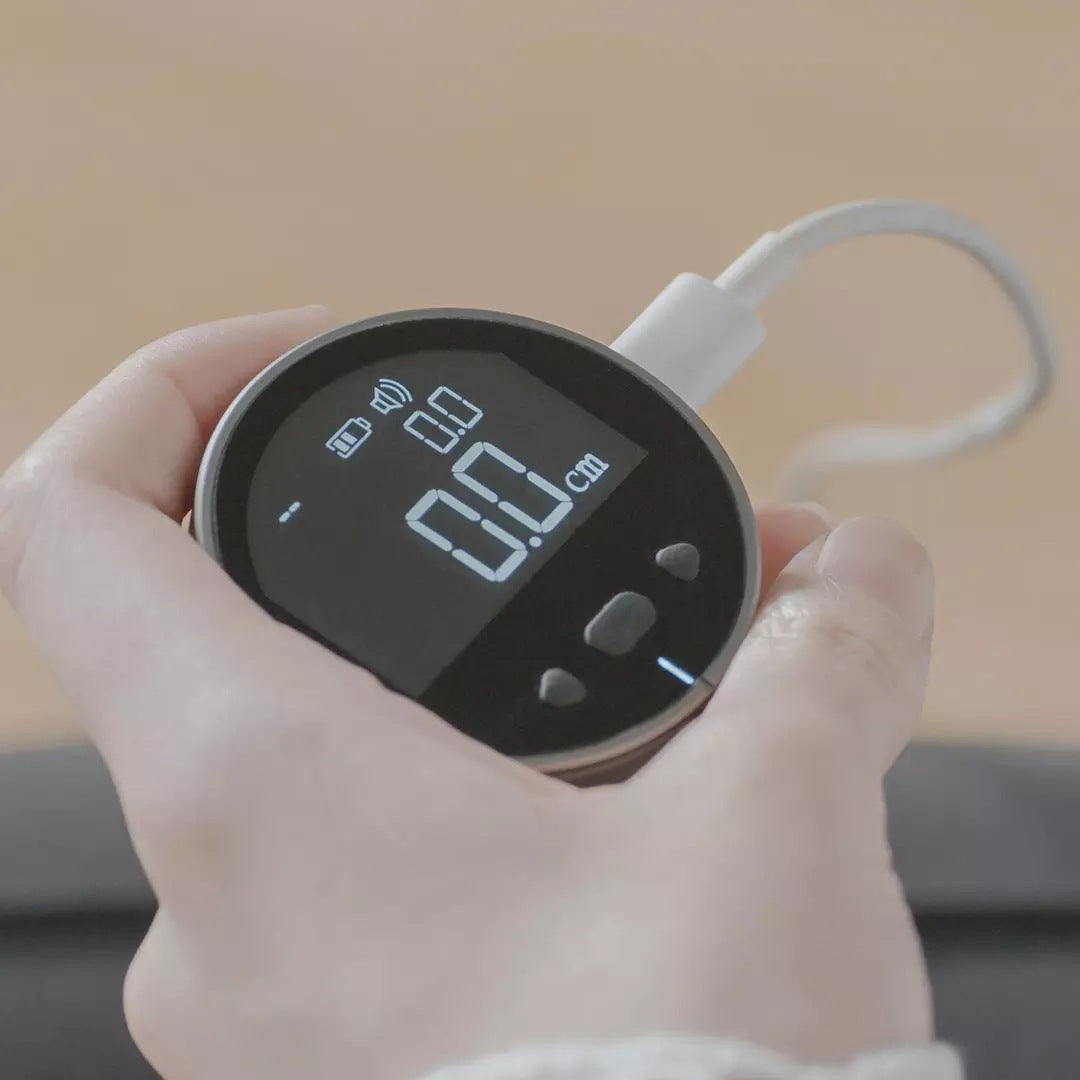 Digital distance measurer with compact rechargeable design and precision LCD display for accurate measurements depiction of charging