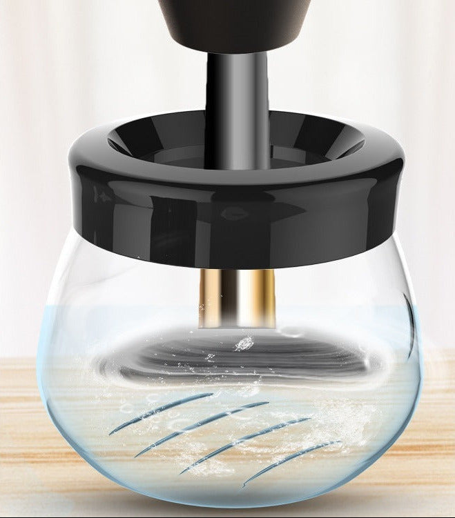 Electric makeup brush cleaner designed to quickly clean and dry makeup brushes using a compact, rechargeable design close shot on container
