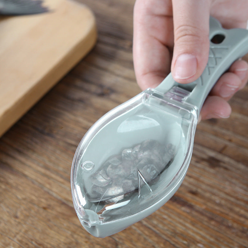 Fish scale scraper tool with protective cover designed for easy fish scaling and kitchen cleaning depiction of fish scale captured inside the tool