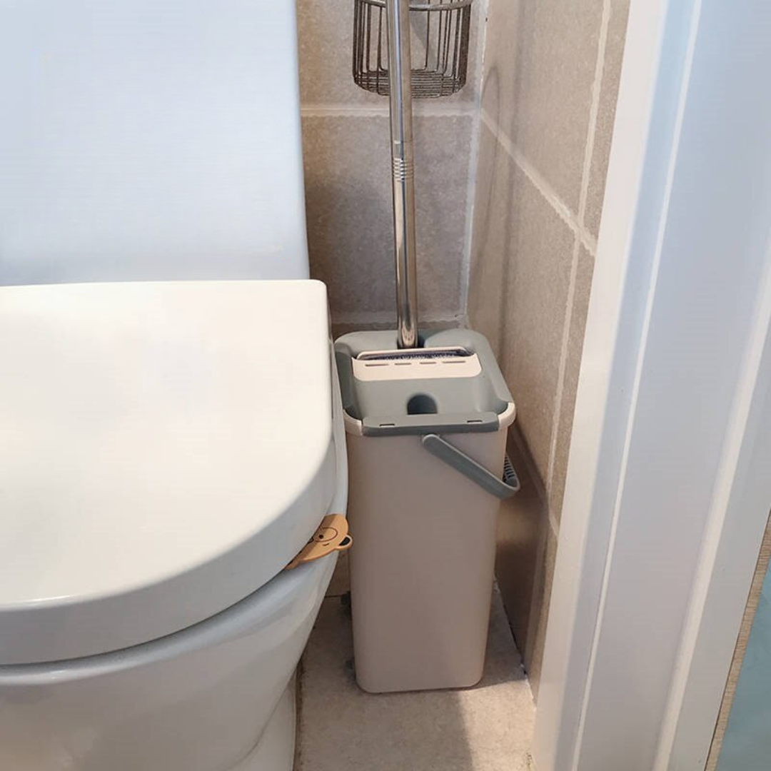 Flat squeeze mop and bucket set with microfiber pads for wet and dry floor cleaning product shot in a bathroom