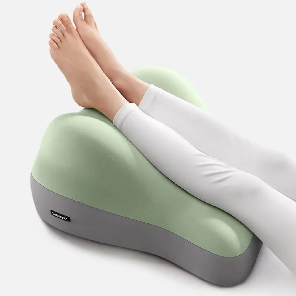 Hip raised bedside sleep cushion made with memory foam for comfortable leg and hip support while resting model shot legs on the cushion alternate angle