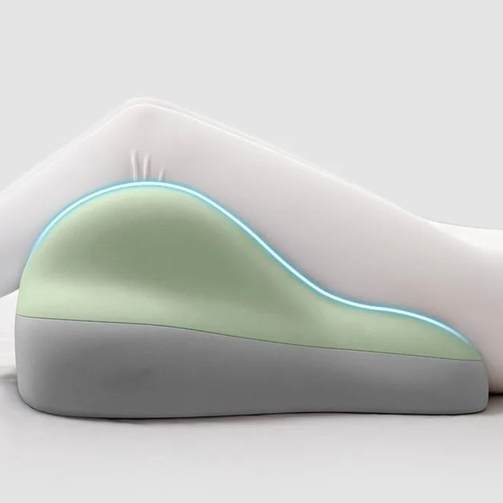 Hip raised bedside sleep cushion made with memory foam for comfortable leg and hip support while resting model shot legs on the cushion