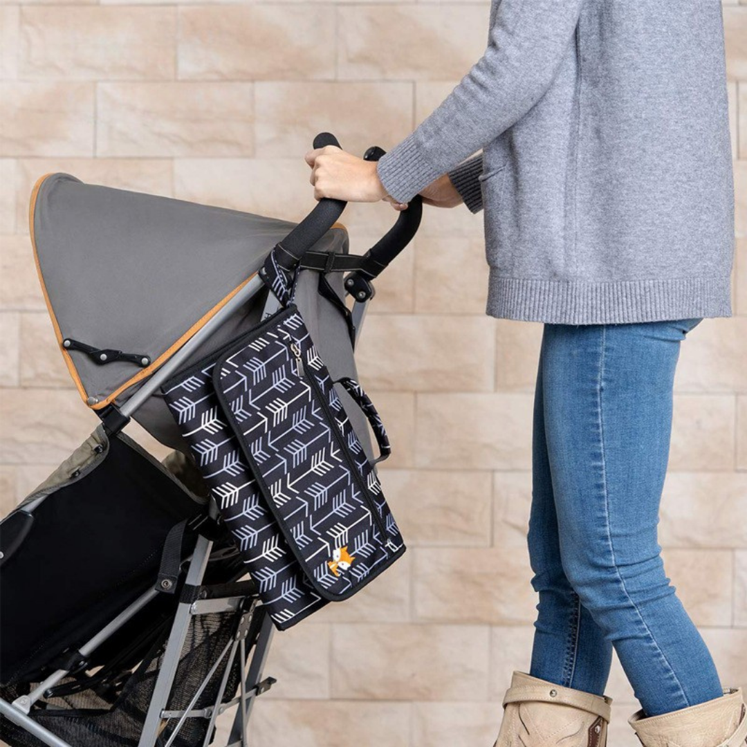 Lil Fox portable folding baby diaper changing pad designed for easy and hygienic diaper changes while traveling or outdoors depiction with a stroller
