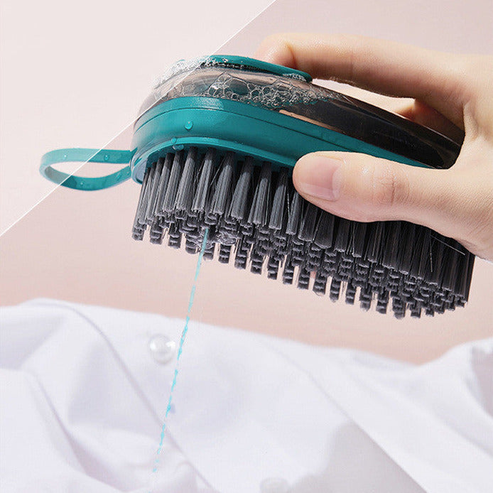 Liquid dispensing shoe cleaning brush with ergonomic grip for washing shoes, clothes, and household items depiction of use on clothes
