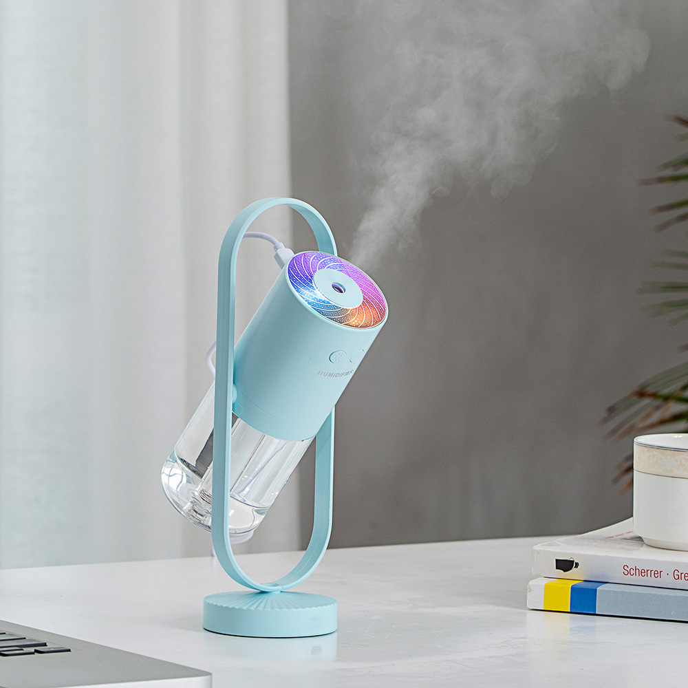 Magic Shadow air humidifier producing cool mist with soft ambient night light blue in light background