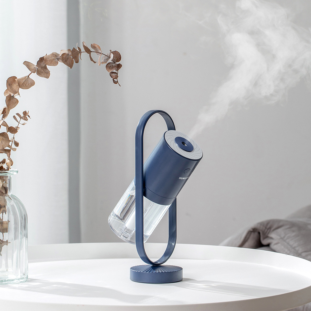 Magic Shadow air humidifier producing cool mist with soft ambient night light dark blue in light background