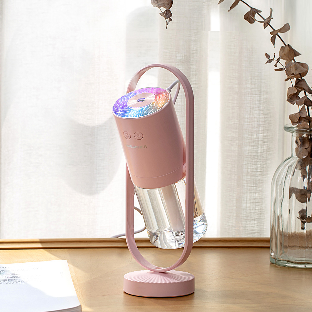 Magic Shadow air humidifier producing cool mist with soft ambient night light pink in light background