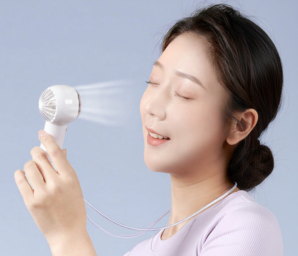 Mini portable turbo fan with USB rechargeable design for compact personal cooling on the go depiction of facing towards the face