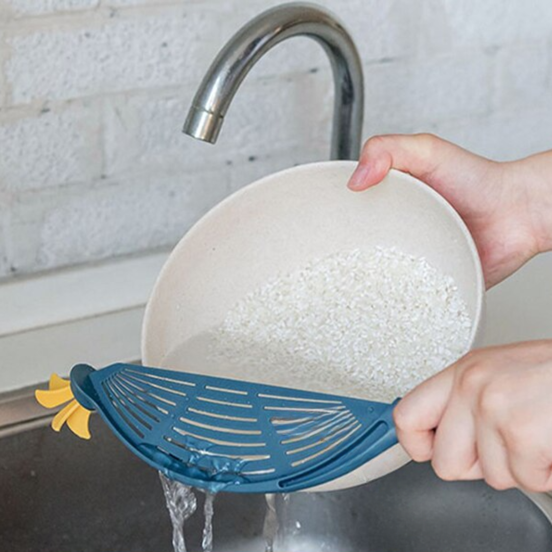 Multifunctional kitchen strainer for draining pasta rice and vegetables compact and easy to use depiction of use as a clip-on pot strainer