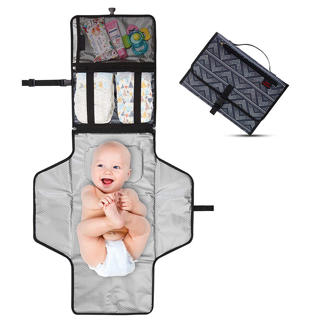 Portable baby diaper changing pad with pockets and headrest for convenient diaper changes