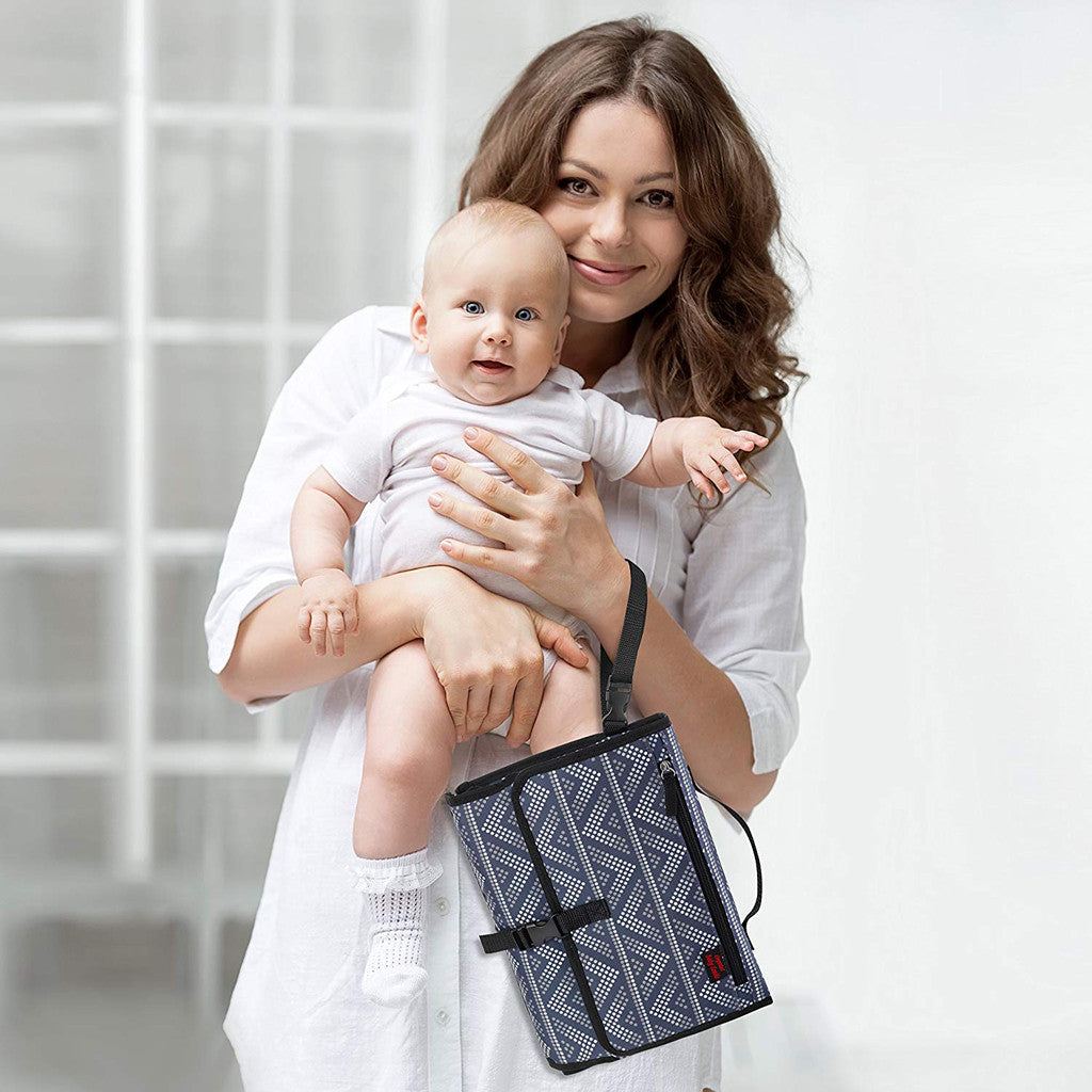 Portable baby diaper changing pad with pockets and headrest for convenient diaper changes model shot with a mother