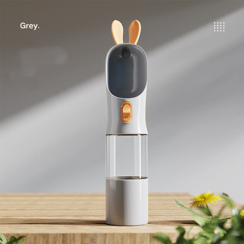 Portable pet water bottle with built-in food container designed for convenient travel and outdoor walks with cats and dogs in grey color (Color: Grey)