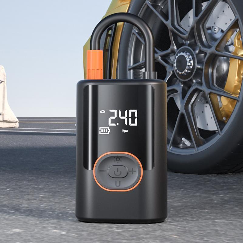 Portable tire inflator with preset modes and power bank function for car bike and ball inflation product shot next to a tire
