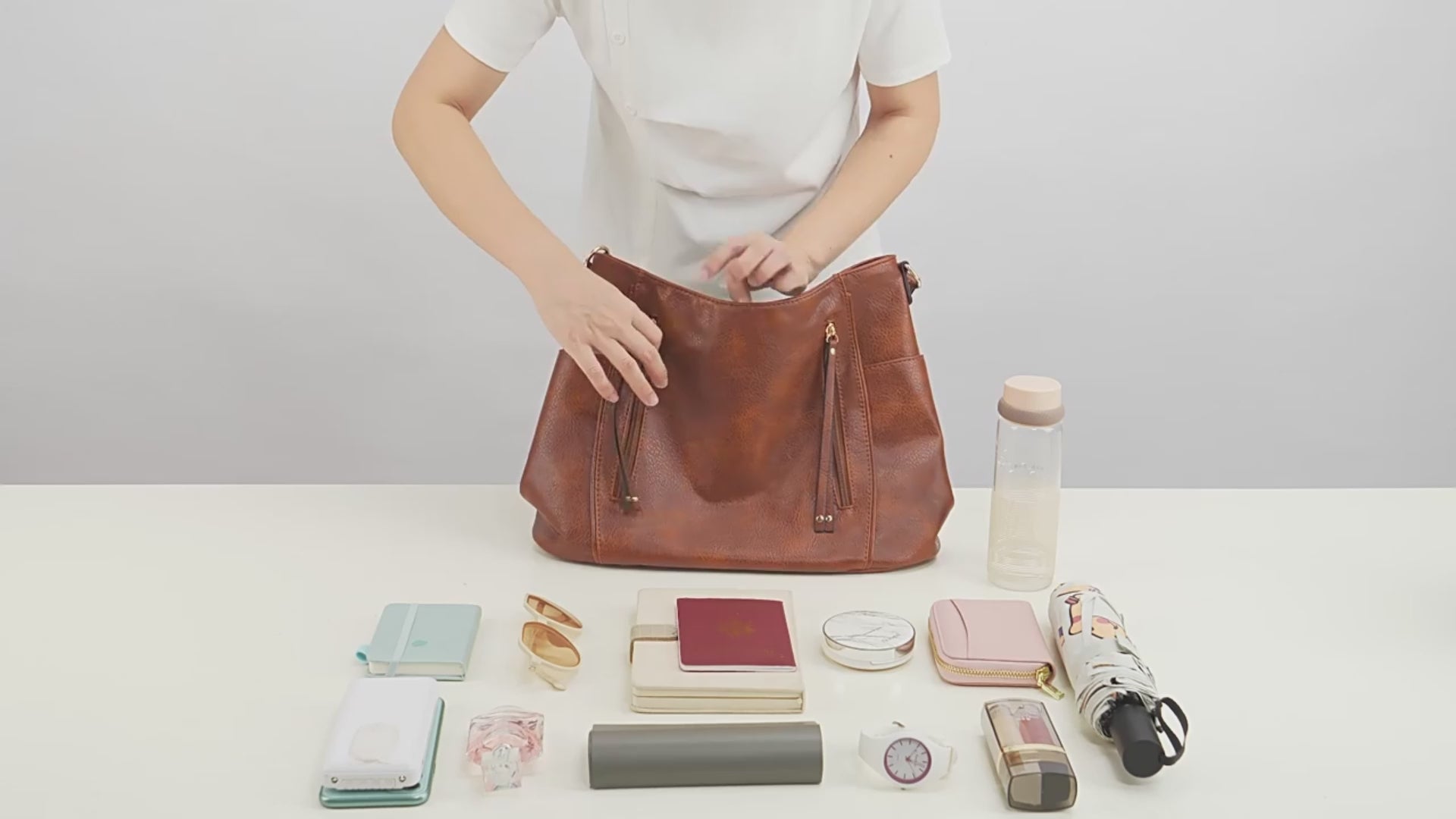 Women’s large capacity shoulder bag in brown color with soft leather look and multiple compartments for everyday use video