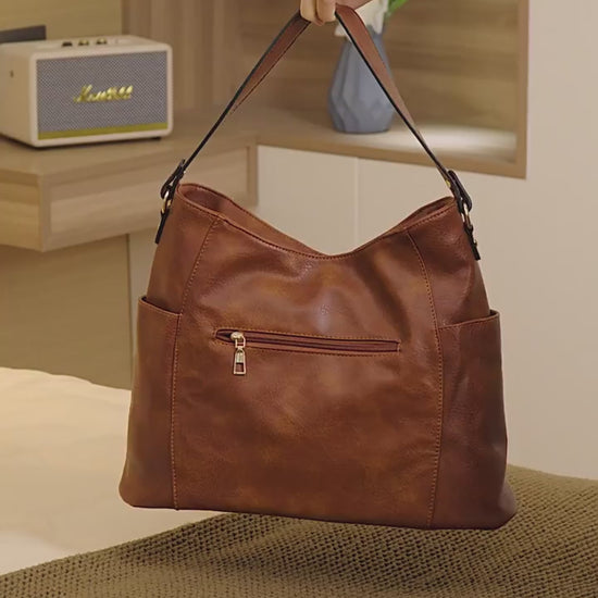 Women’s large capacity shoulder bag in brown color with soft leather look and multiple compartments for everyday use fashion video