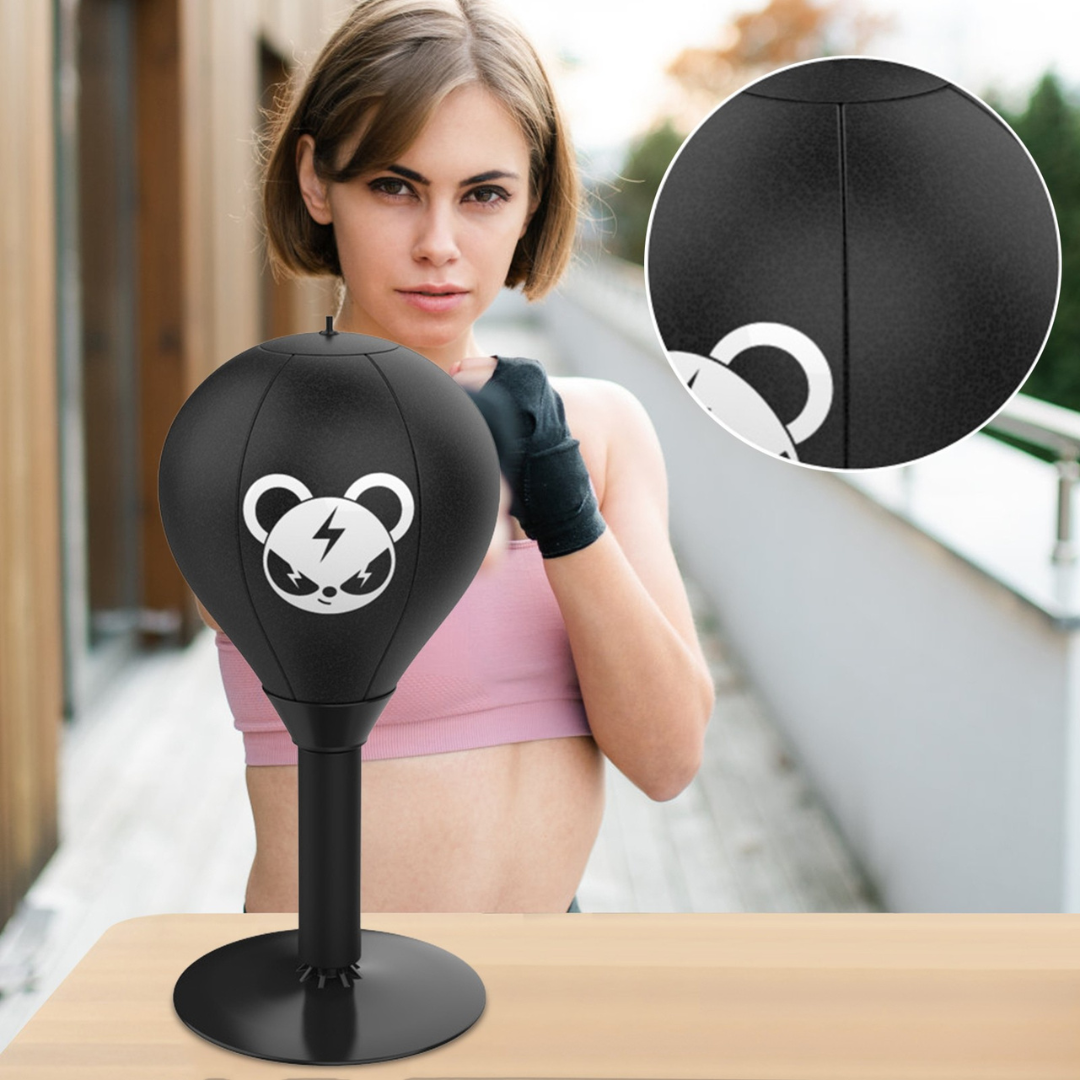 Desktop punching bag with suction base for stress relief featuring a soft impact surface and durable spring for repeated use model shot