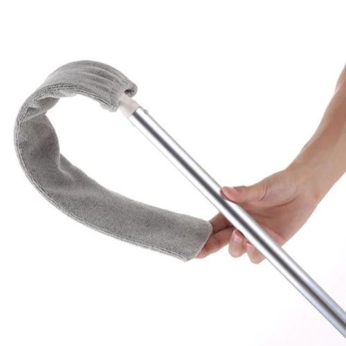Retractable gap dust cleaner with microfiber head for cleaning under furniture and tight spaces depiction of flexibility