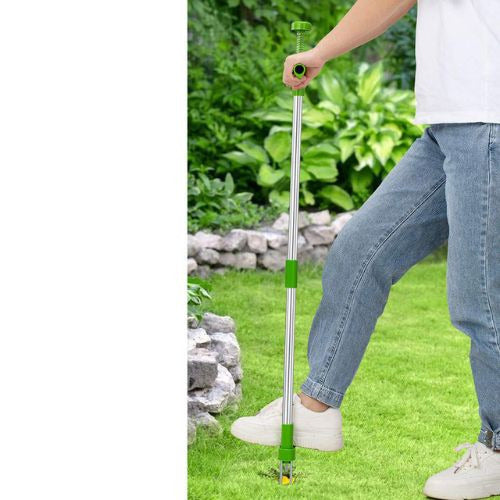 Stand up weed puller tool with long handle and foot pedal for easy root removal depiction of use
