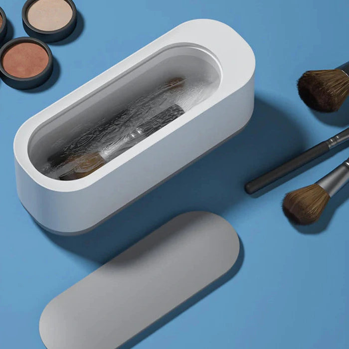 Ultrasonic glasses and jewelry cleaner for cleaning rings eyewear and small items depiction of cleaning makeup brushes