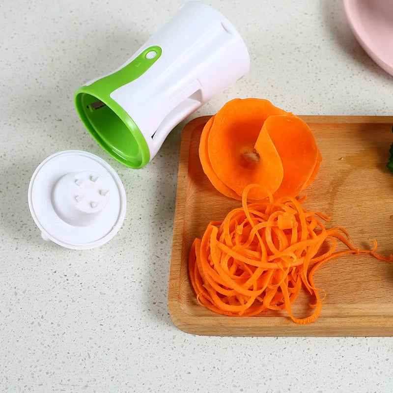 Vegetable spiralizer with interchangeable blades for creating zucchini noodles spirals and ribbon cuts another depiction of spiralizing carrot
