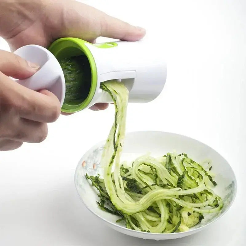 Vegetable spiralizer with interchangeable blades for creating zucchini noodles spirals and ribbon cuts depiction of spiralizing zucchini