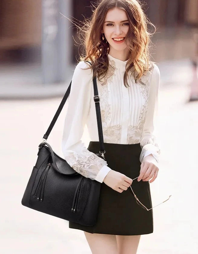 Women’s large capacity shoulder bag with soft leather look and multiple compartments for everyday use model shot