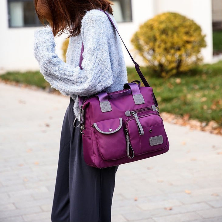 Women’s waterproof multi-pocket shoulder bag with large capacity for everyday commuting and casual use model shot side