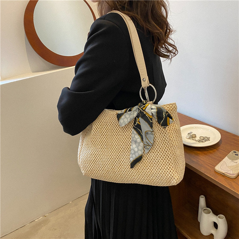Woven straw shoulder bag in khaki color with large capacity and summer beach style model shot