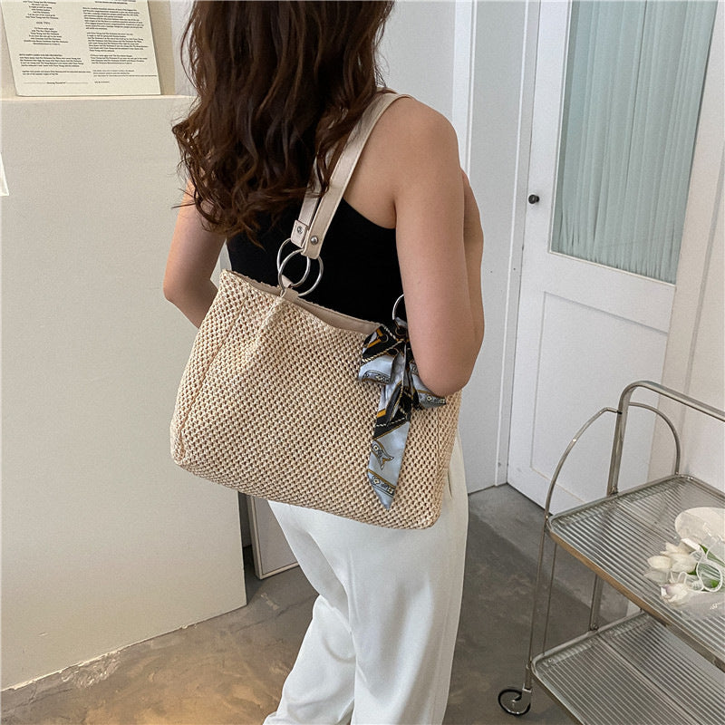 Woven straw shoulder bag in white color with large capacity and summer beach style model shot